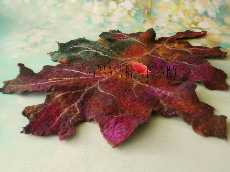 Wet-felted merino wool maple leaf photo prop with sculpted veins and blended autumn colours