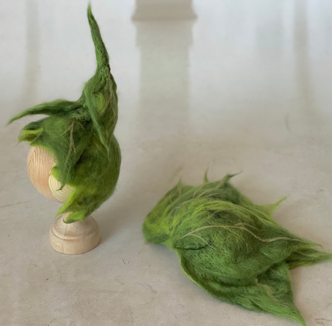 Left side view of hand-felted Woodland Green leaf bonnet with natural tonal detailing
