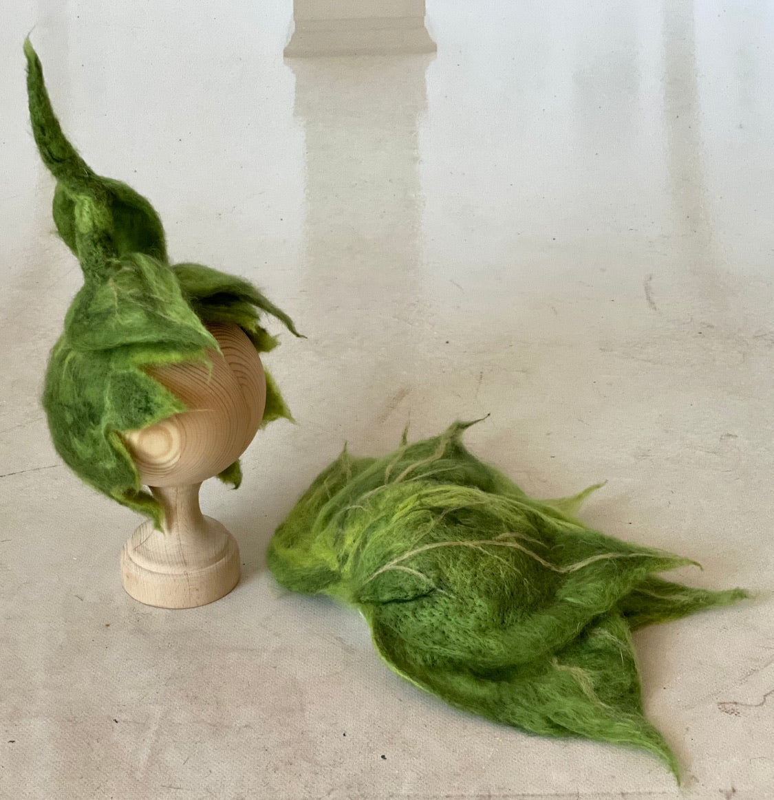Right side view of Woodland Green felted leaf bonnet showing sculptural leaf shape